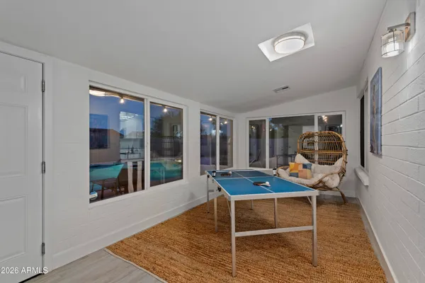a room with wooden floor and gym equipment