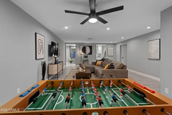 a bed room with furniture pool table and a ceiling fan