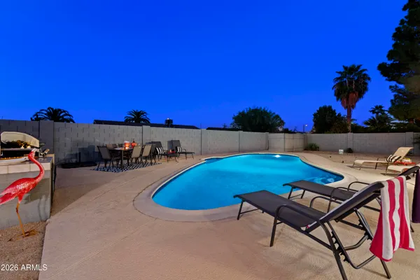 a view of swimming pool with outdoor seating