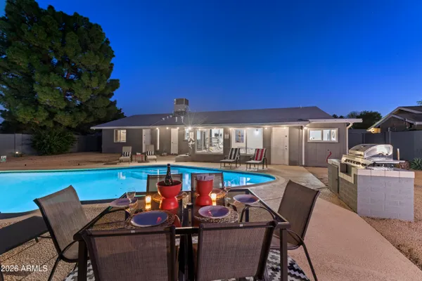 a view of a patio with swimming pool table and chairs