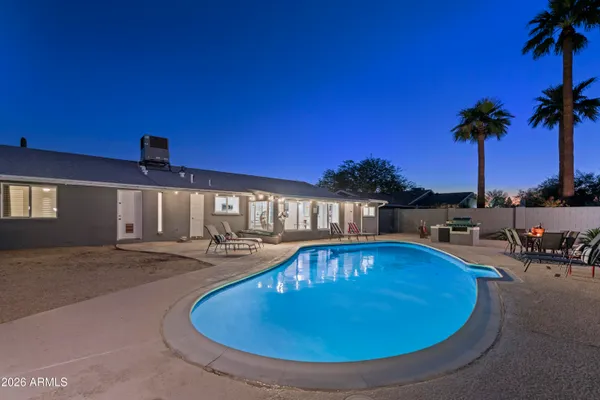 a view of a swimming pool with a table and chairs