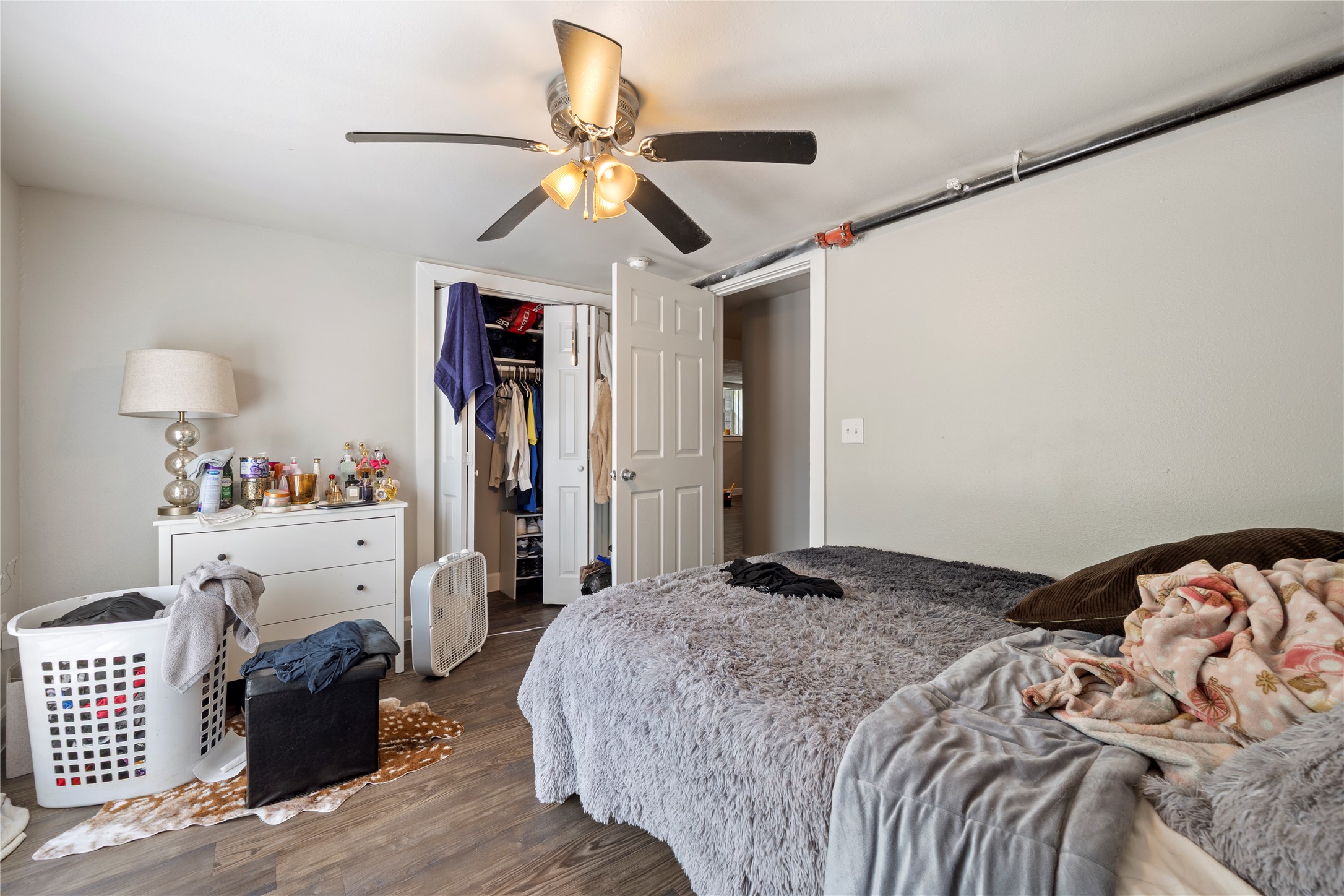 201 West 31st Street, Unit E Austin, TX 78705 - Photo 5 of 16 A comfortable bedroom featuring practical flooring and a spacious closet for storage.