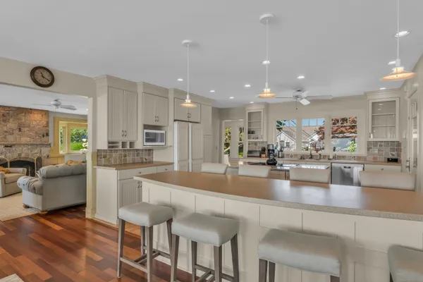 a large kitchen with lots of counter space and furniture