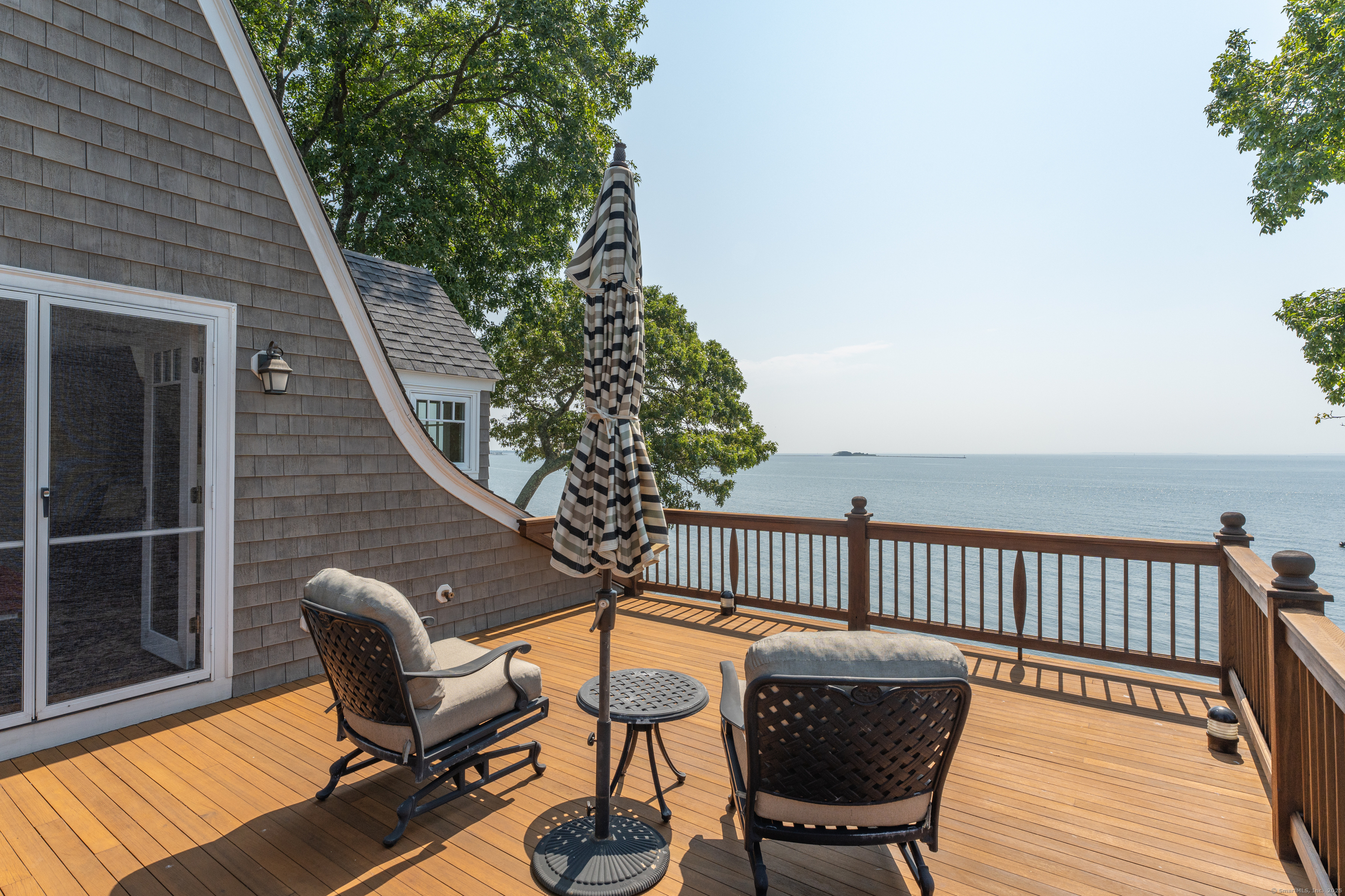 55 Shore Road Clinton, CT 06413 - Photo 18 of 33 a balcony with wooden floor table and chairs