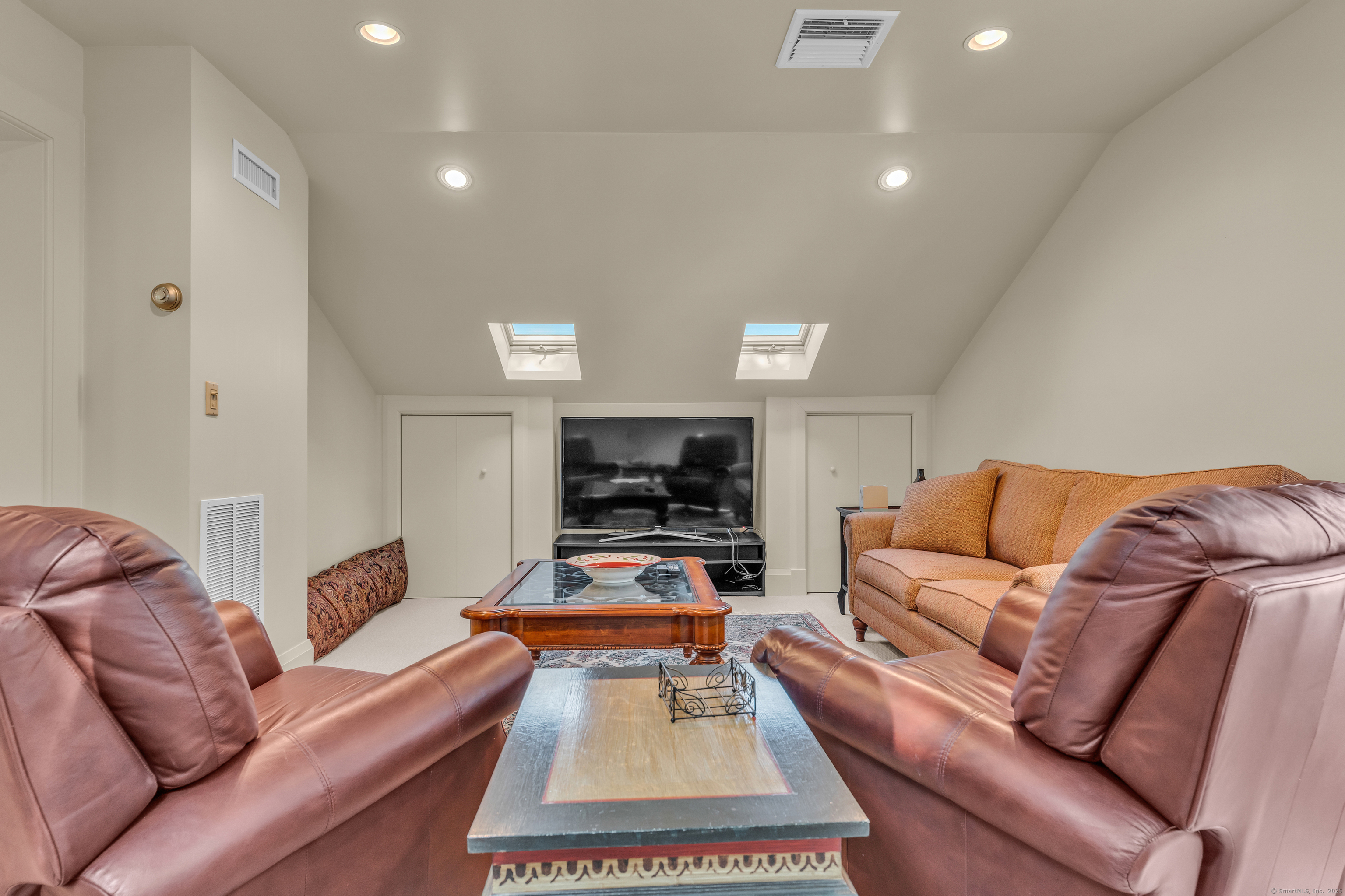 55 Shore Road Clinton, CT 06413 - Photo 26 of 33 a living room with furniture and a flat screen tv