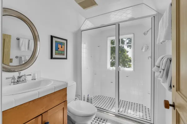 a bathroom with a toilet a sink and a mirror