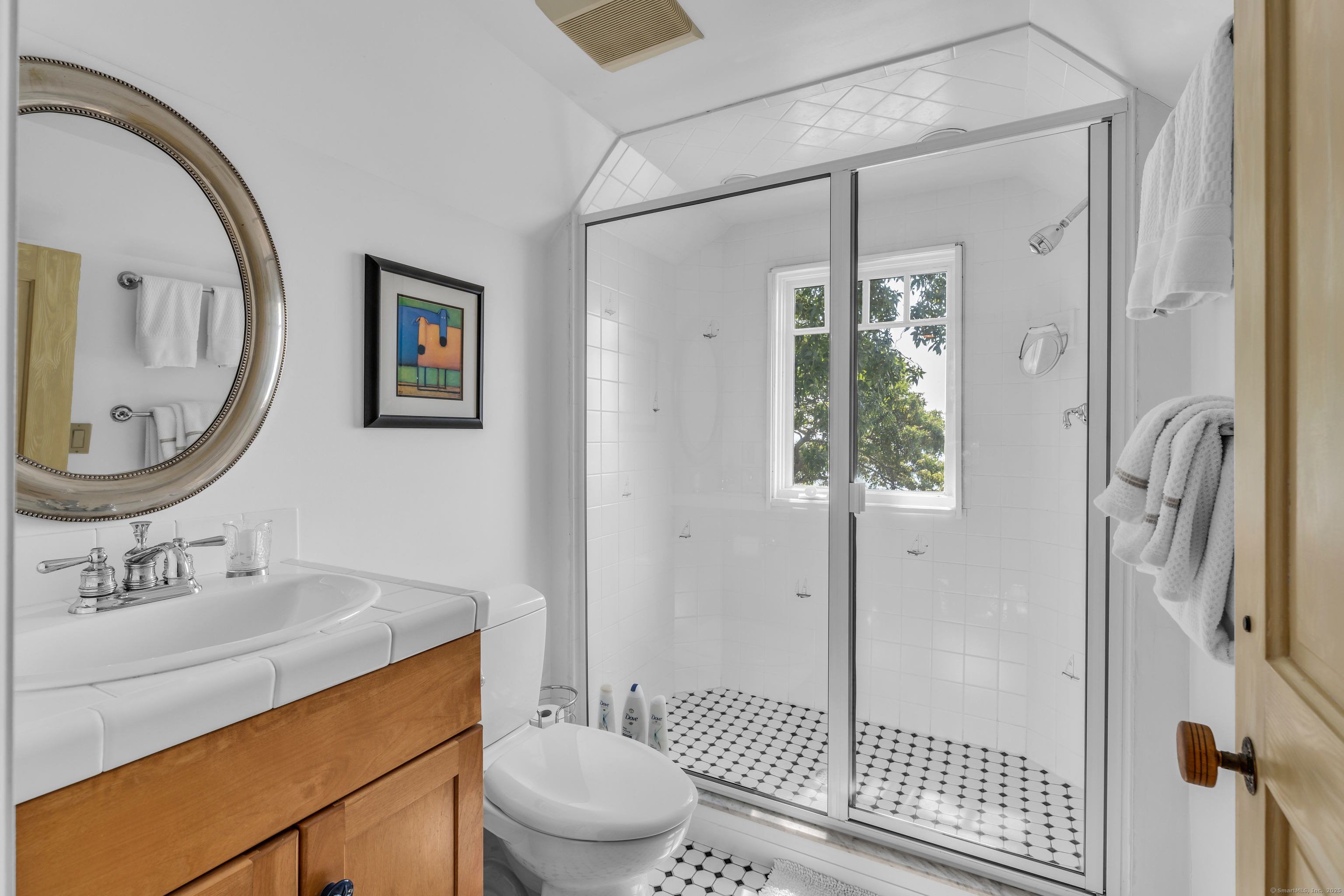 55 Shore Road Clinton, CT 06413 - Photo 27 of 33 a bathroom with a toilet a sink and a mirror