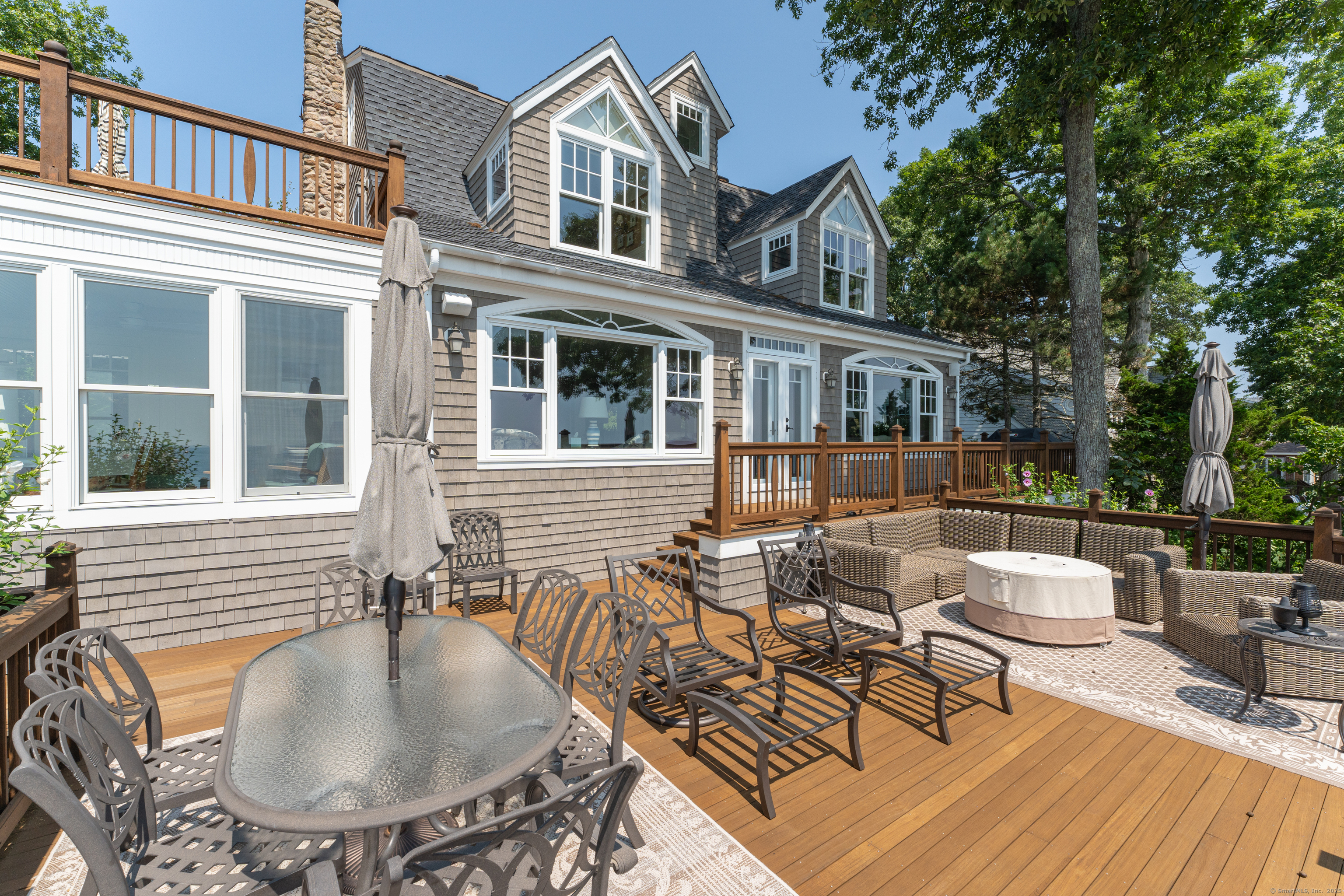 55 Shore Road Clinton, CT 06413 - Photo 30 of 33 a patio with couches table and chairs and potted plants