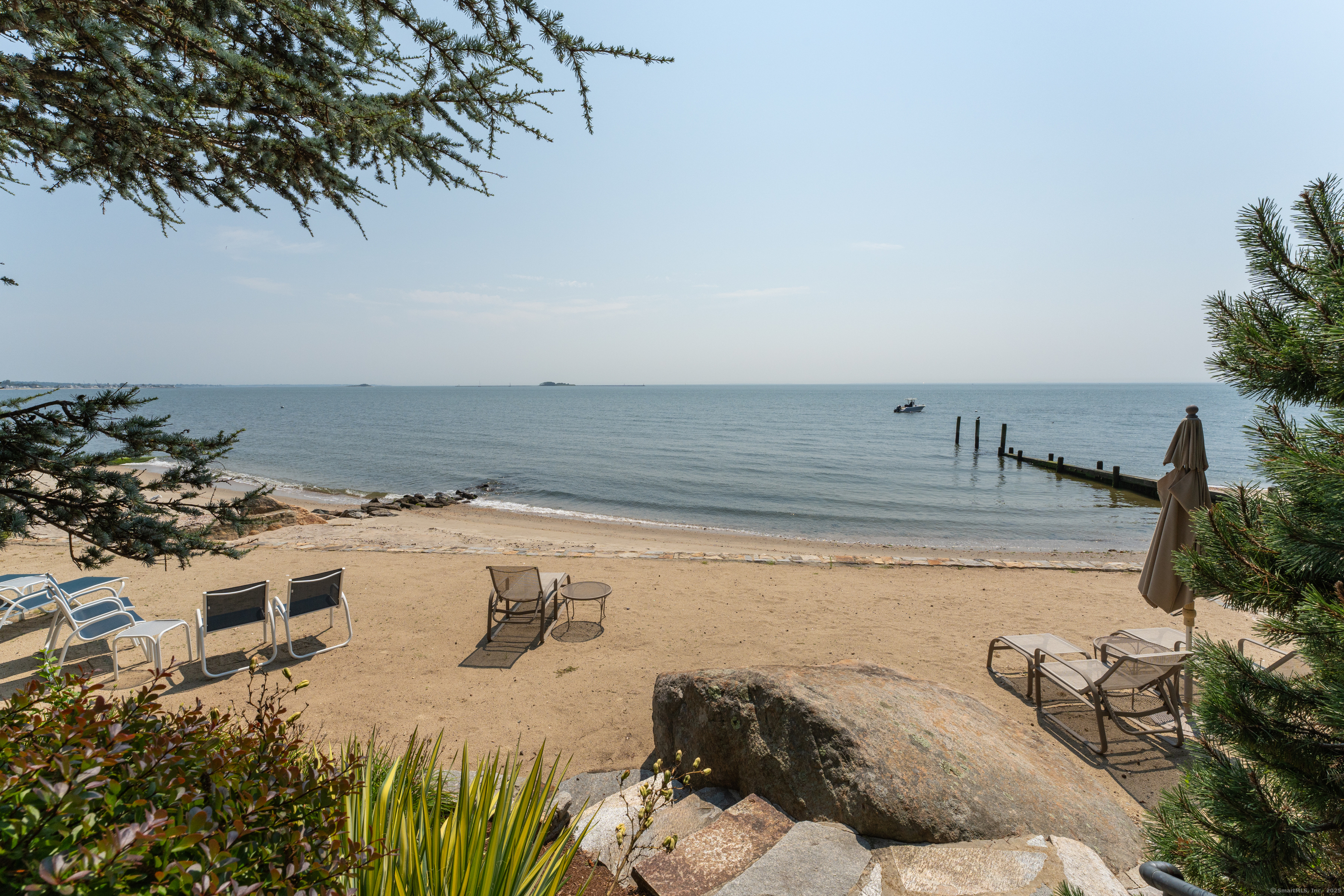 55 Shore Road Clinton, CT 06413 - Photo 32 of 33 a view of a swimming pool table and chairs