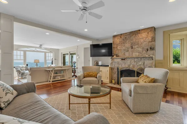 a living room with furniture a fireplace a flat screen tv and potted plant