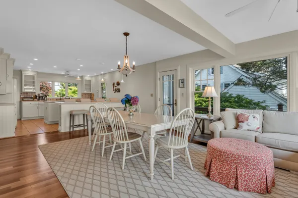 a dining room with furniture a rug and a chandelier