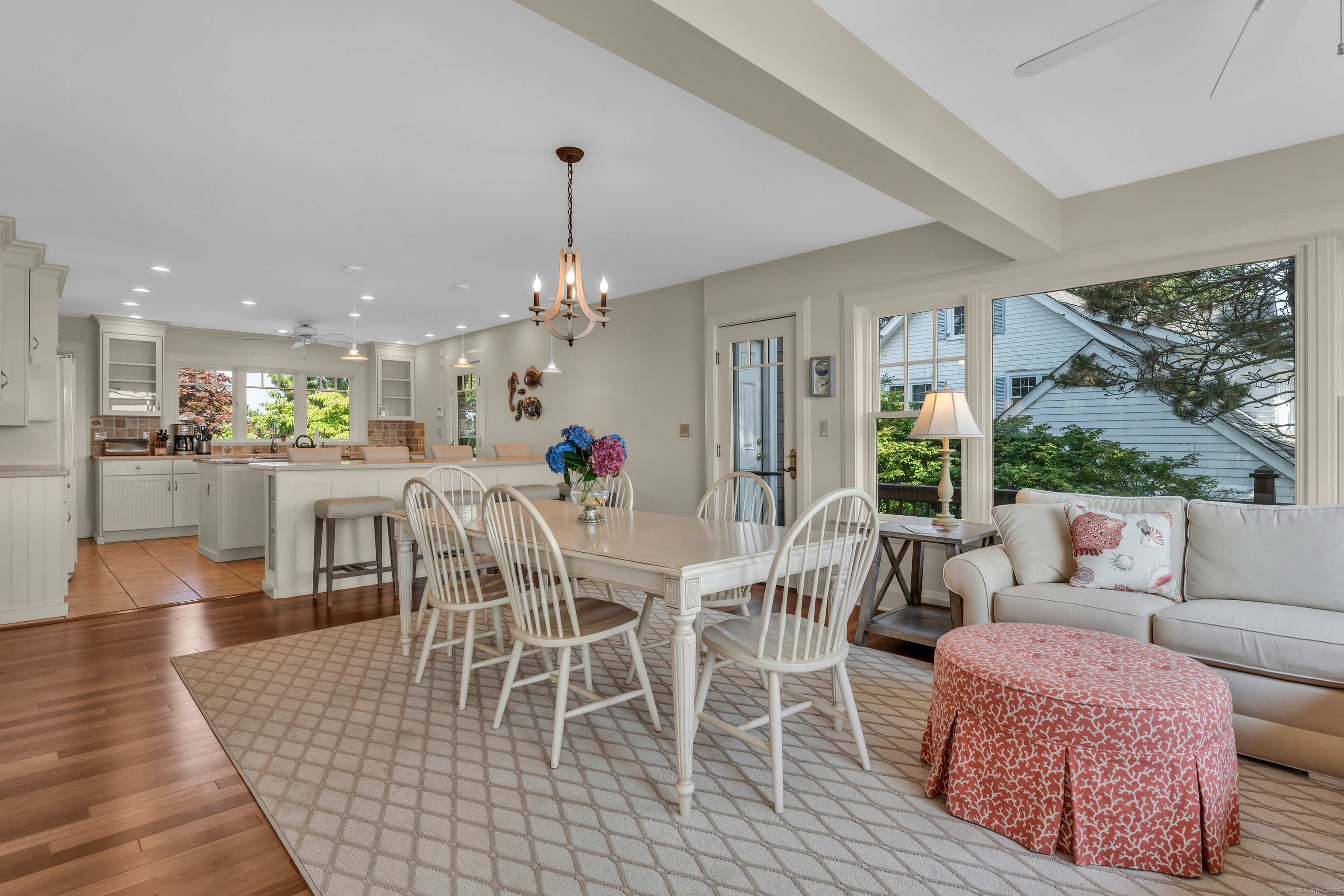 55 Shore Road Clinton, CT 06413 - Photo 10 of 33 a dining room with furniture a rug and a chandelier