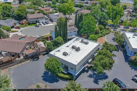 an aerial view of a house with table and chairs