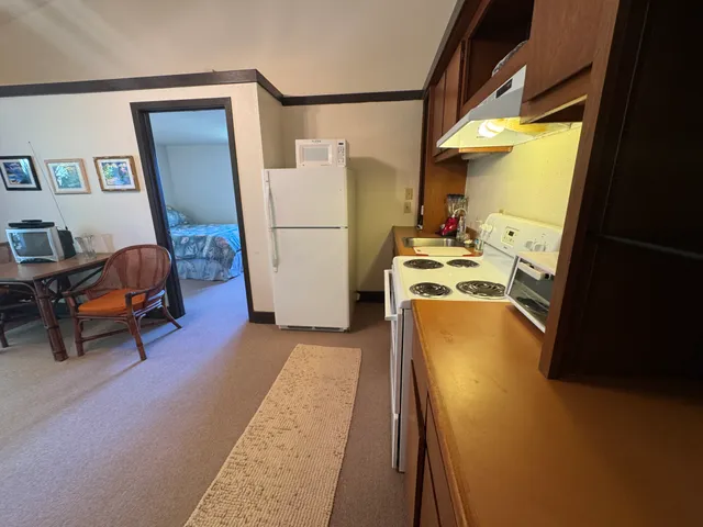 a kitchen with a refrigerator and a stove