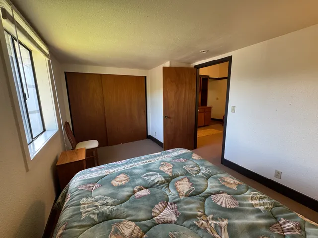 a bedroom with a bed and a window