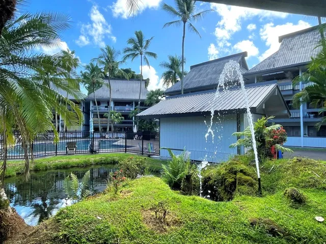 a view of a house with a patio and a garden