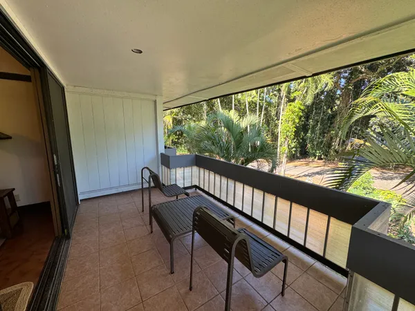 a view of a porch with furniture and a gate