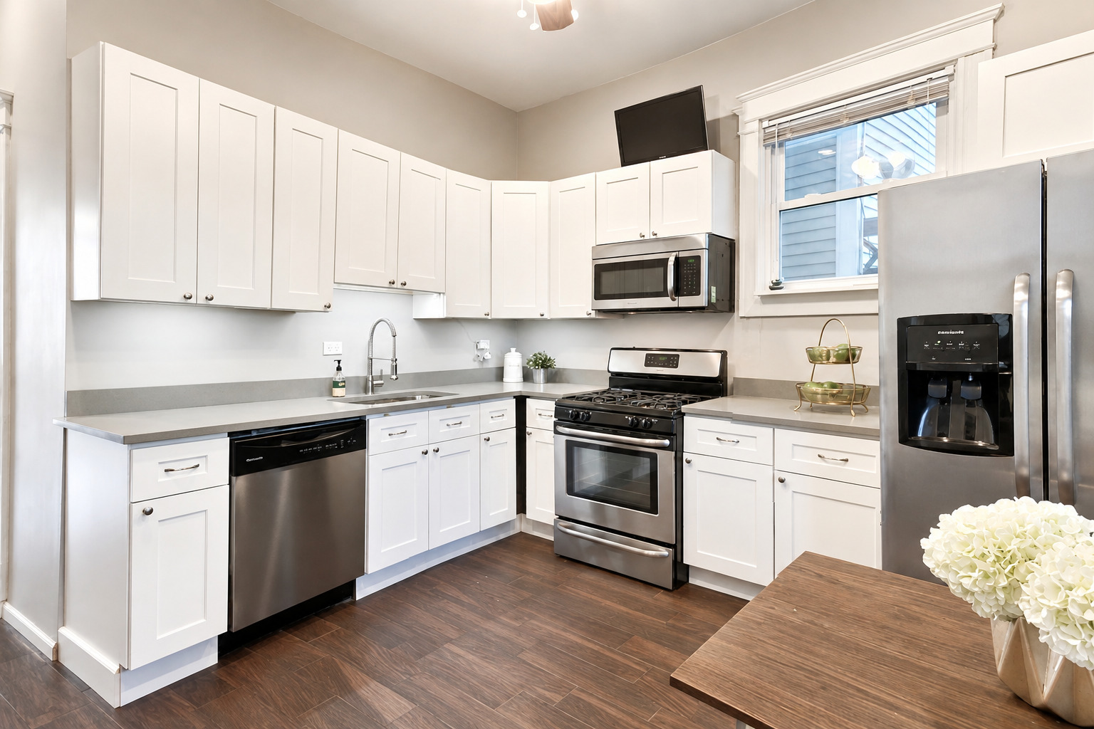 3749 North Seminary Avenue, Unit 1 Chicago, IL 60613 - Photo 8 of 25 a kitchen with stainless steel appliances granite countertop a stove a sink and a microwave