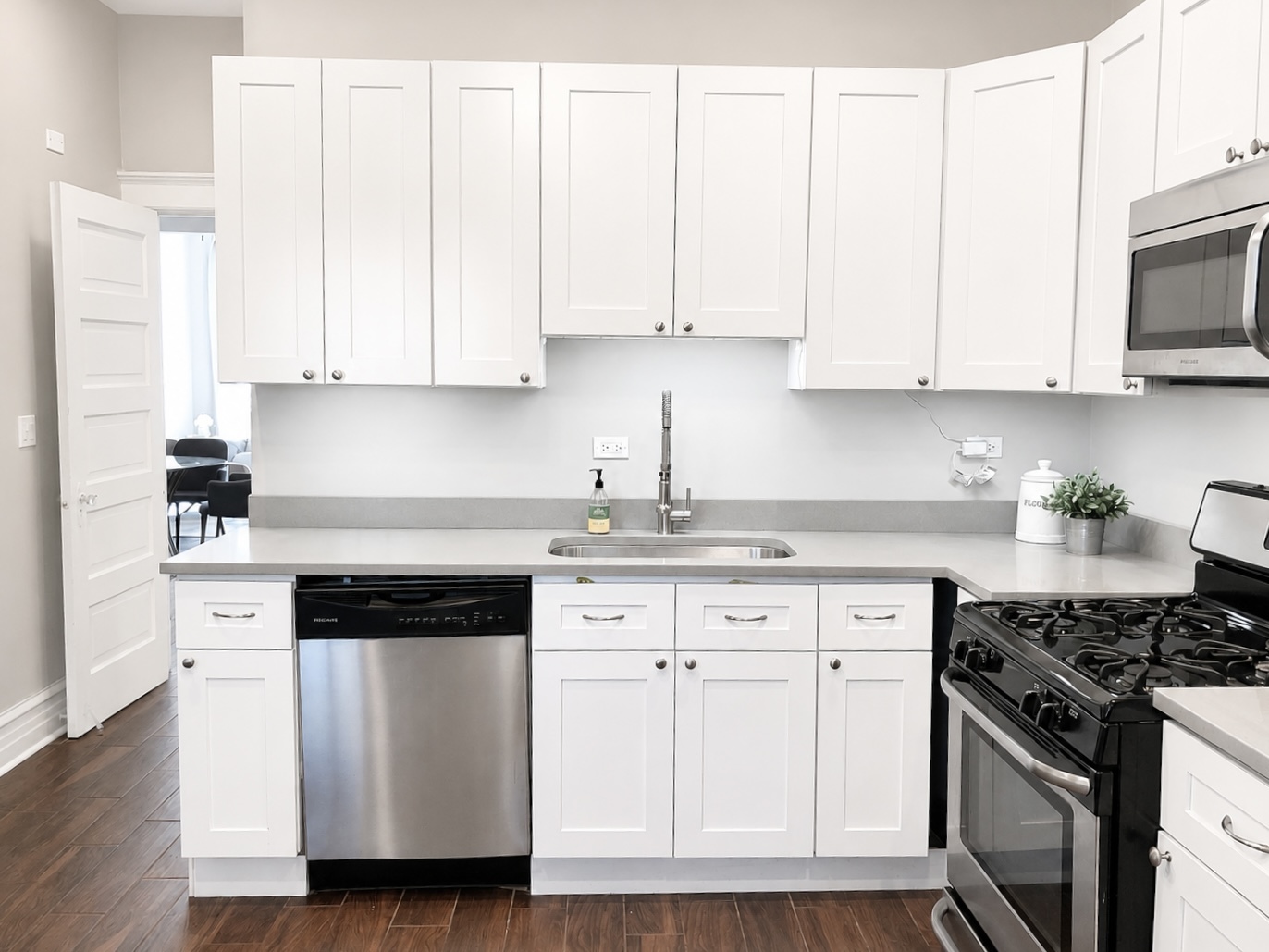 3749 North Seminary Avenue, Unit 1 Chicago, IL 60613 - Photo 10 of 25 a kitchen with granite countertop white cabinets and stainless steel appliances