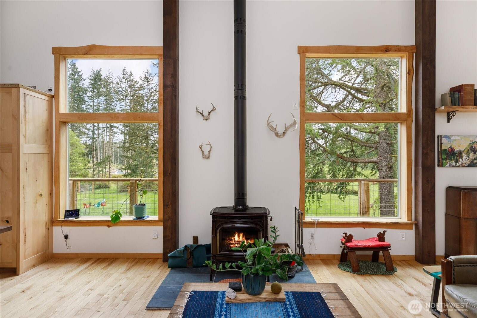 5287 Maxwelton Road Langley, WA 98260 - Photo 12 of 40 a living room with large windows and a fireplace