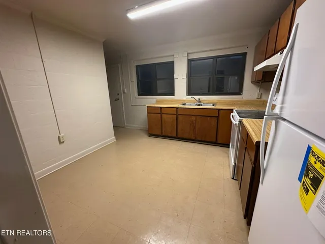 a kitchen with stainless steel appliances a refrigerator and a stove