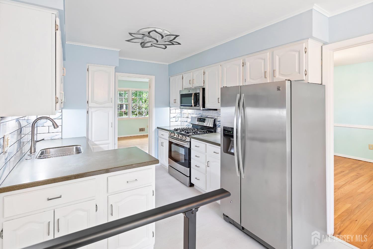 10 Woodruff Road Edison, NJ 08820 - Photo 5 of 18 a kitchen with refrigerator a sink and cabinets