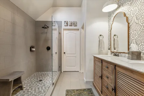a spacious bathroom with a double vanity sink and a mirror