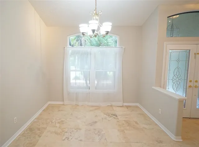 a view of an empty room with a fireplace and a window