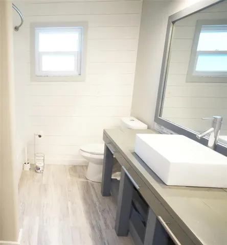 a bathroom with a tub sink and a toilet
