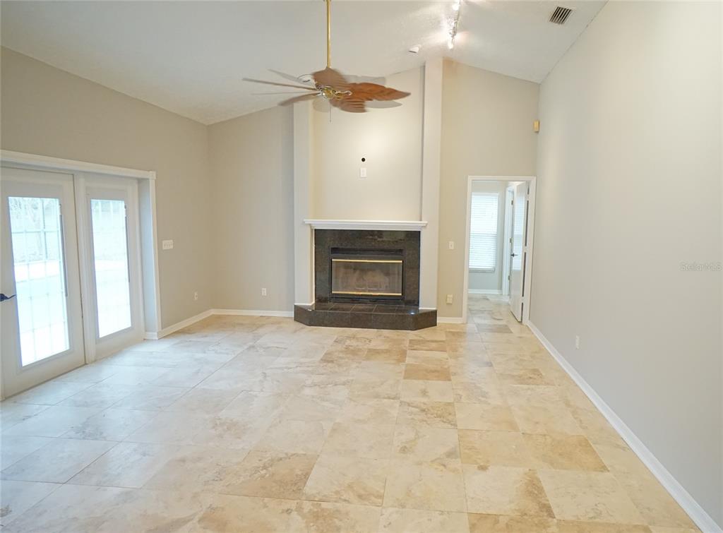 3807 Turkey Oak Drive Valrico, FL 33596 - Photo 28 of 44 an empty room with fireplace and windows