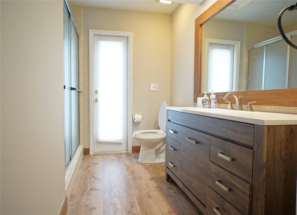 3807 Turkey Oak Drive Valrico, FL 33596 - Photo 29 of 44 a bathroom with a sink a toilet and a large mirror