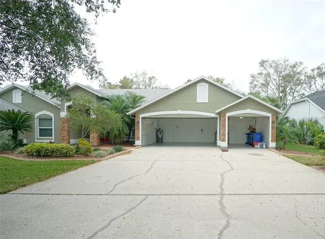 a front view of house with garage and trees