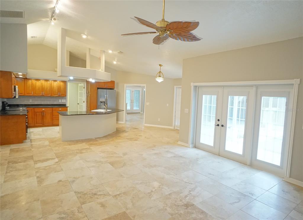 3807 Turkey Oak Drive Valrico, FL 33596 - Photo 36 of 44 a view of a kitchen with a stove and a chandelier fan