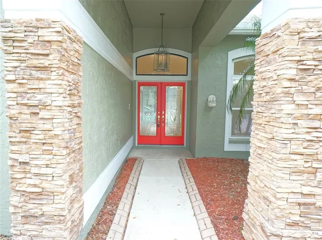 a view of a large room with wooden floor and windows