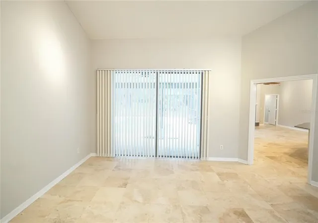 an empty room with a wooden floor and sliding door