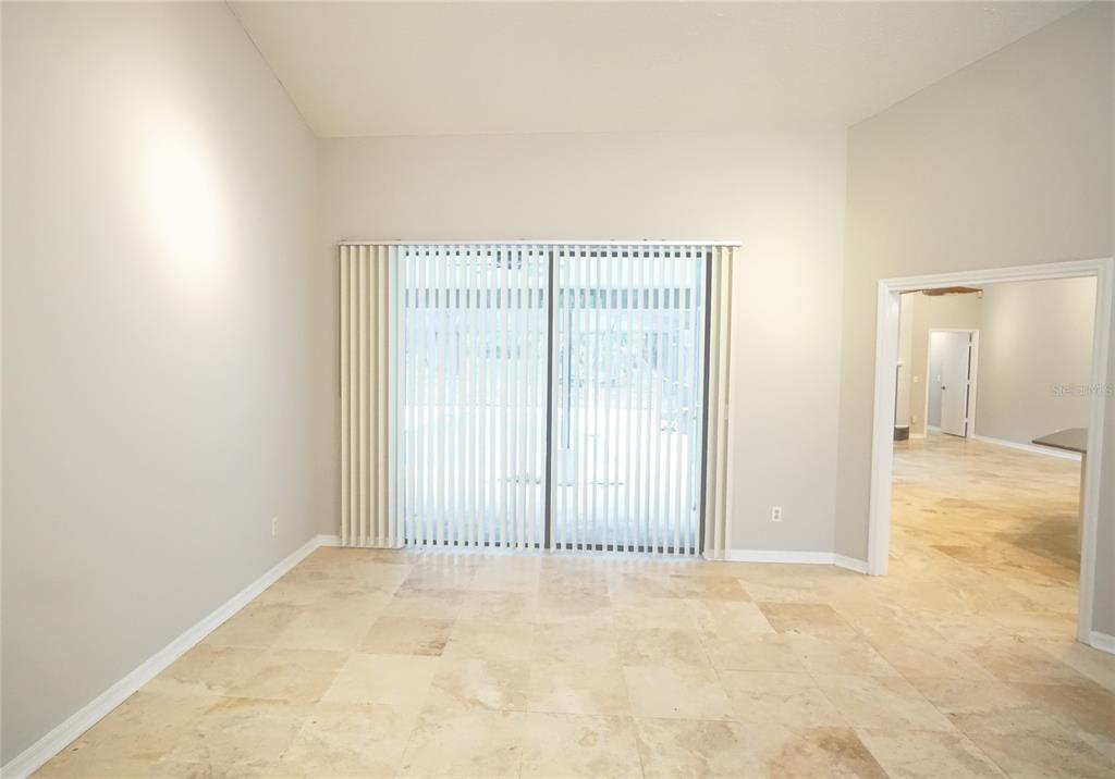 3807 Turkey Oak Drive Valrico, FL 33596 - Photo 6 of 44 an empty room with a wooden floor and sliding door