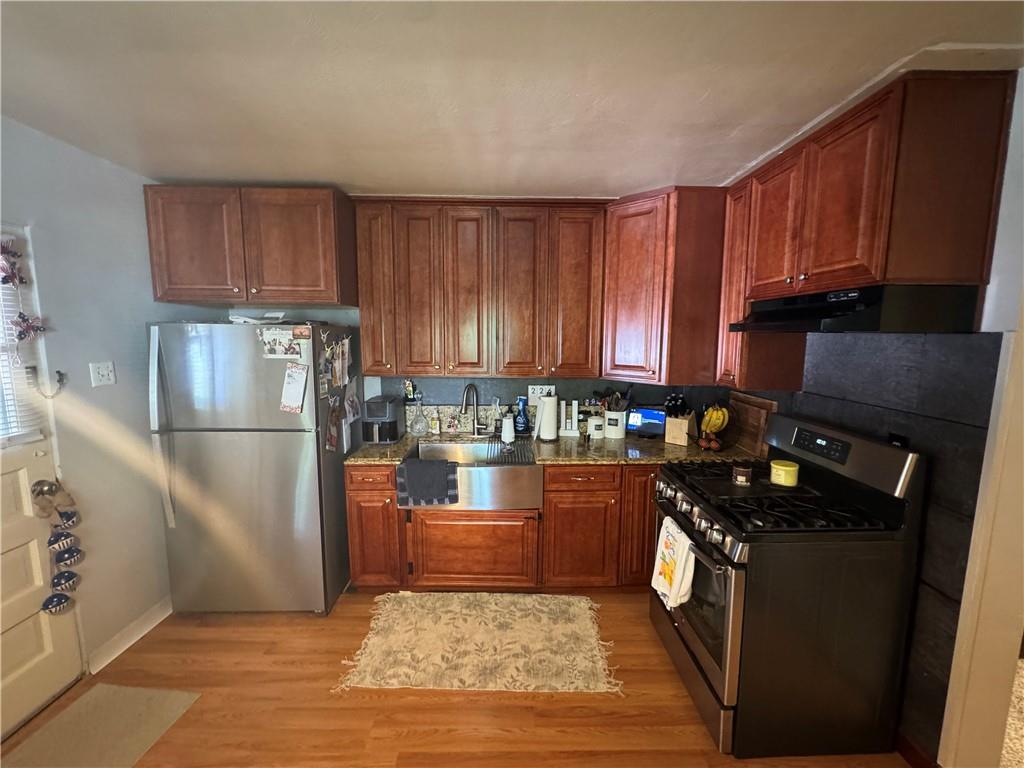 15-16 Ring Street Rural Ridge, PA 15075 - Photo 11 of 39 a kitchen with granite countertop stainless steel appliances a stove a refrigerator a sink and dishwasher