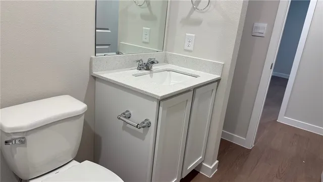 a white toilet sitting next to a bathroom sink