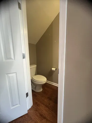 a white toilet sitting next to a small sink