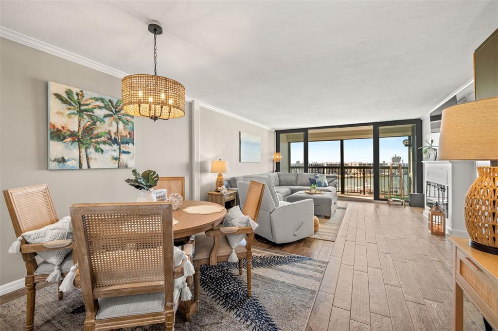 9525 Blind Pass Road, Unit 507 St. Pete Beach, FL 33706 - Photo 13 of 53 a view of a dining room with furniture a chandelier and large windows