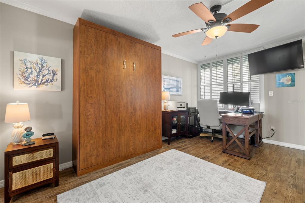 9525 Blind Pass Road, Unit 507 St. Pete Beach, FL 33706 - Photo 21 of 53 a livingroom with workspace and a window
