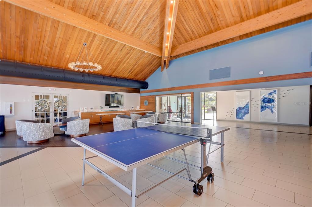 9525 Blind Pass Road, Unit 507 St. Pete Beach, FL 33706 - Photo 38 of 53 a kitchen with a table chairs and a stove