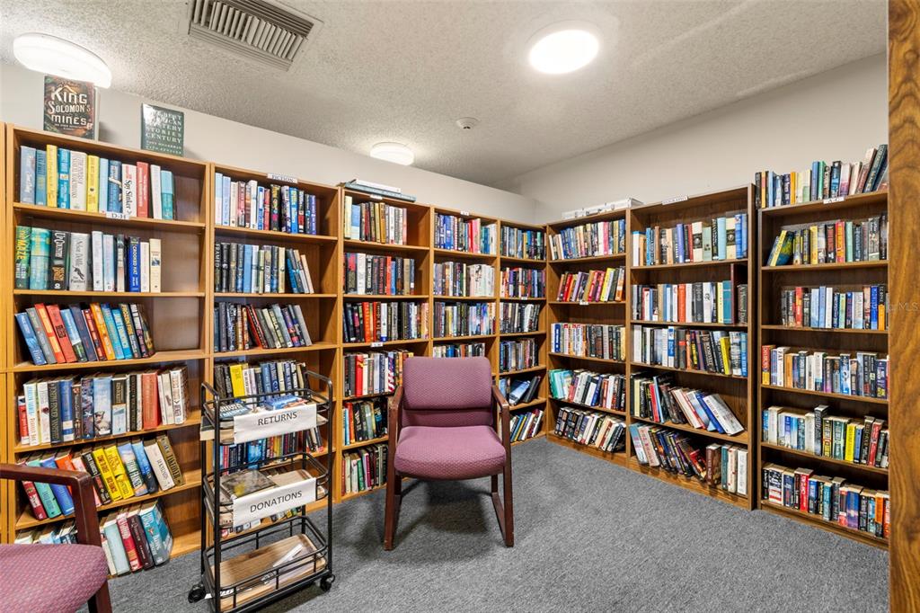 9525 Blind Pass Road, Unit 507 St. Pete Beach, FL 33706 - Photo 39 of 53 a view of a book and with a book shelf