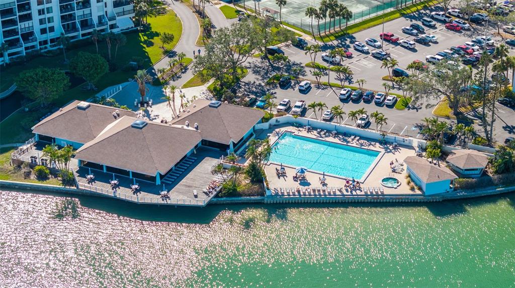 9525 Blind Pass Road, Unit 507 St. Pete Beach, FL 33706 - Photo 42 of 53 an aerial view of a house with a garden and lake view