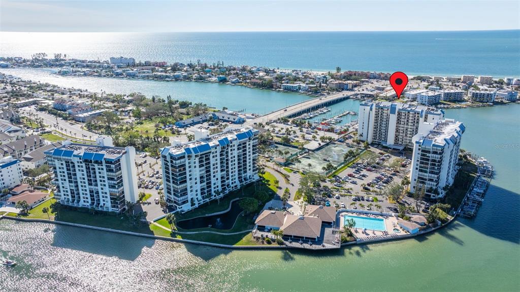 9525 Blind Pass Road, Unit 507 St. Pete Beach, FL 33706 - Photo 44 of 53 a view of a house with outdoor space and sitting space
