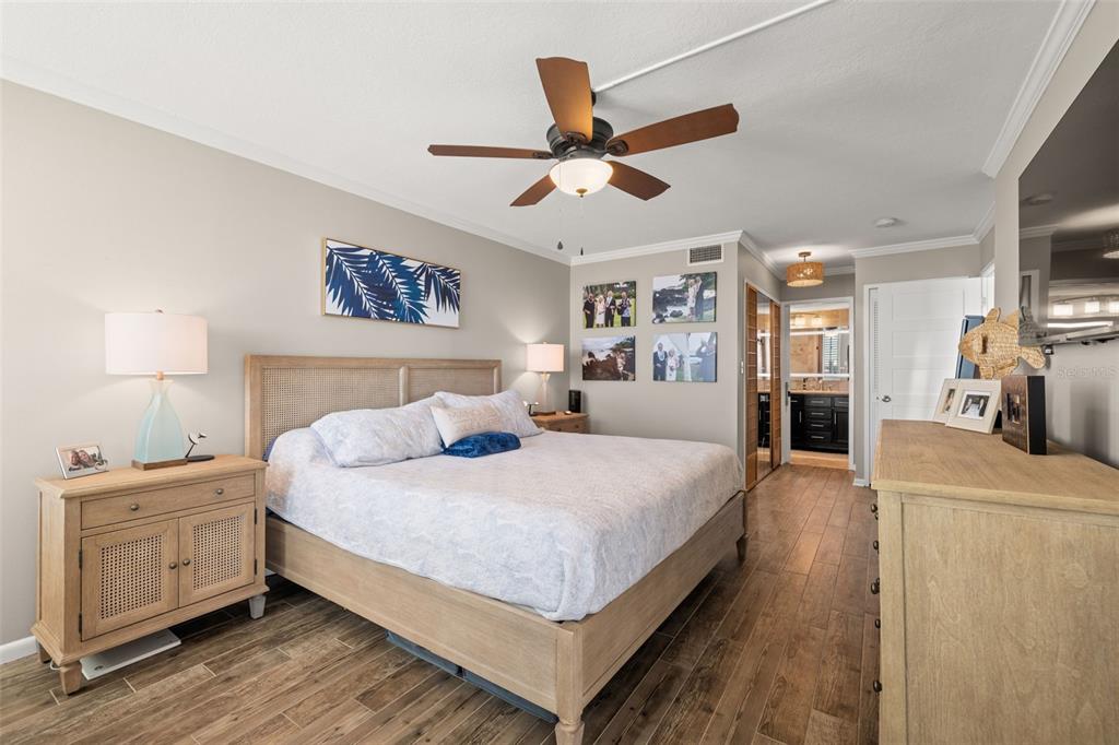 9525 Blind Pass Road, Unit 507 St. Pete Beach, FL 33706 - Photo 5 of 53 a bedroom with a large bed and a chandelier