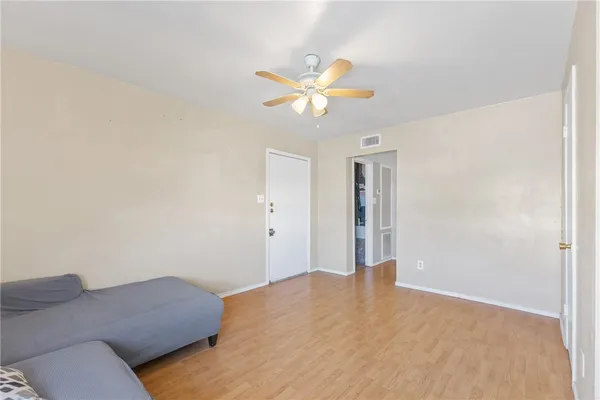 a bedroom with a bed and a chandelier fan