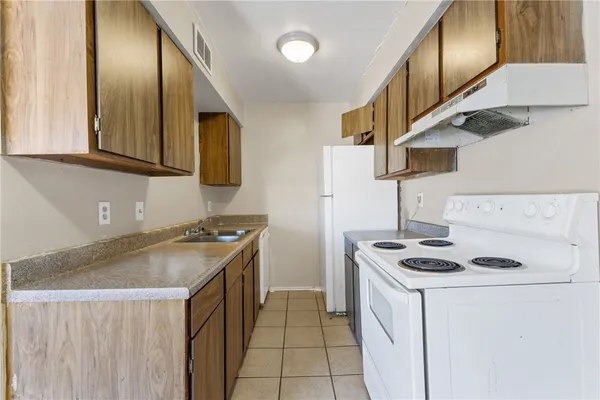 a kitchen that has a sink and a stove