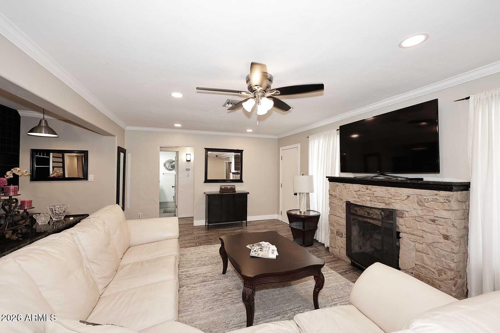 3502 North 22nd Street Phoenix, AZ 85016 - Photo 4 of 35 a living room with furniture a flat screen tv and a fireplace