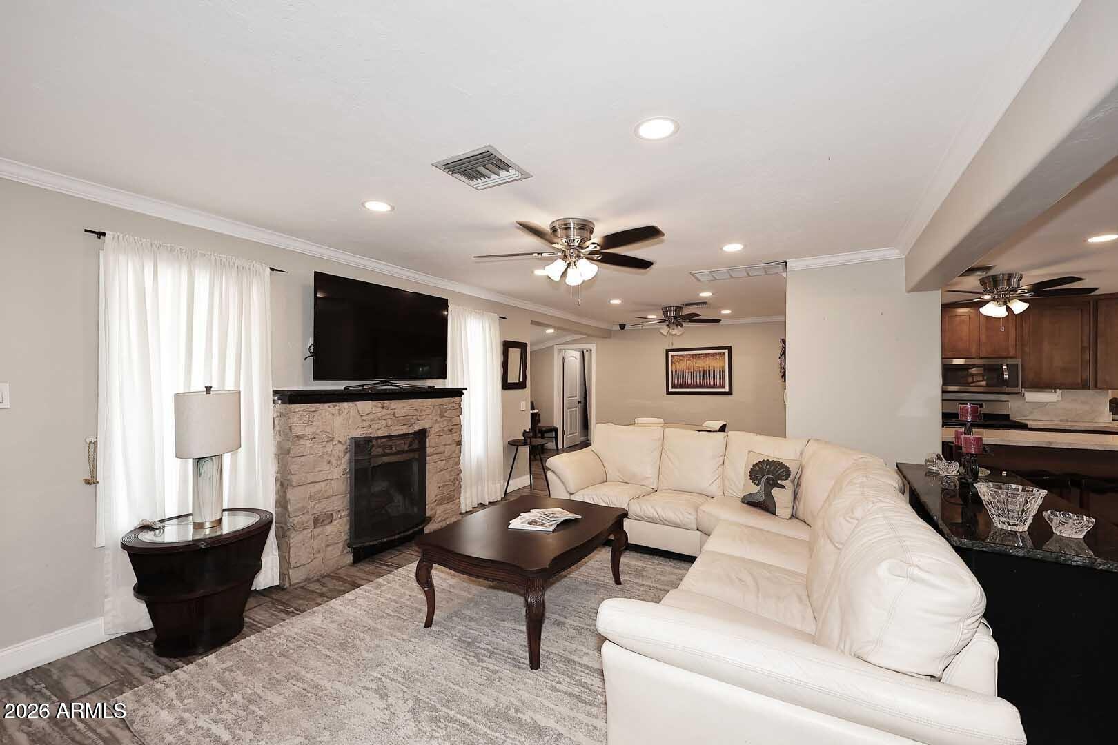 3502 North 22nd Street Phoenix, AZ 85016 - Photo 5 of 35 a living room with furniture a flat screen tv and a fireplace
